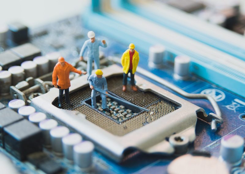 Miniature people Network Engineers At mainborad computer