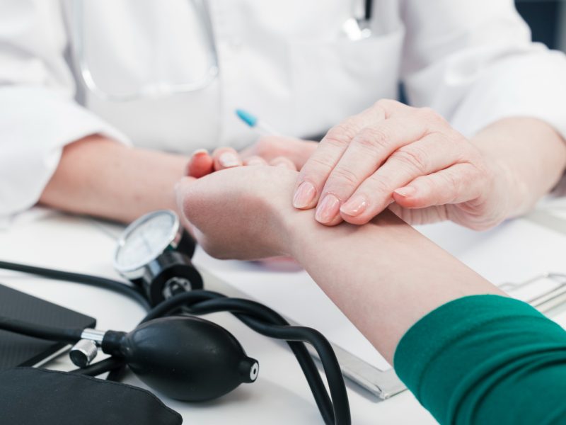 doctor-s-hand-tending-patient